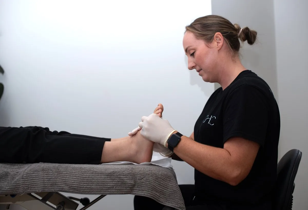 Podiatrist treating a patient's toenail at Gladesville Healthcare
